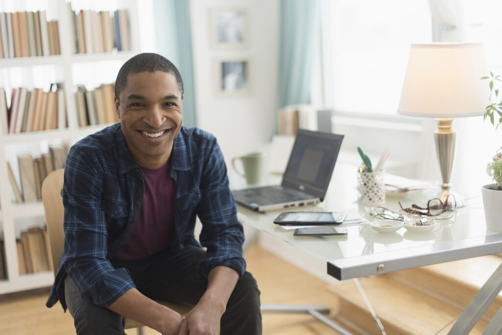 Black businessman smiling at desk